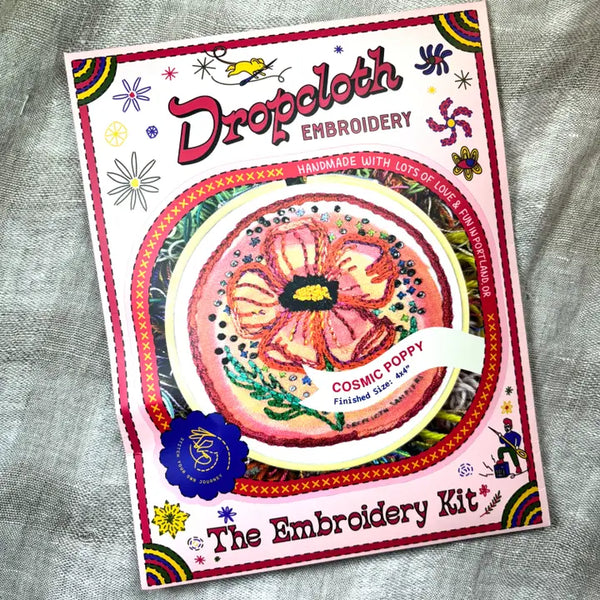 Embroidery kit packaging with a colorful design on a textured fabric background