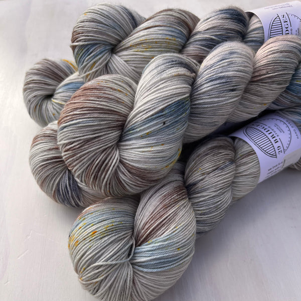 Five skeins of multicolored yarn on a white background
