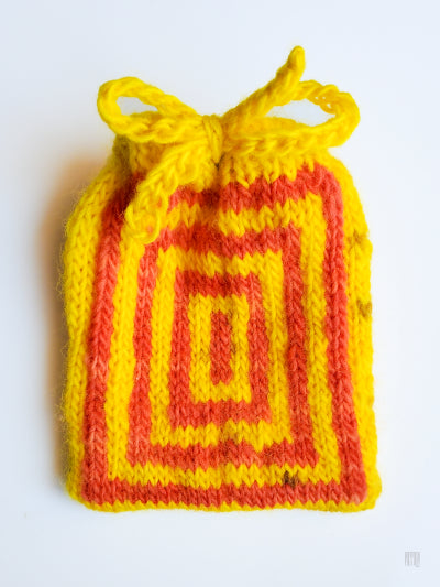 Yellow and orange knitted drawstring bag on a white background