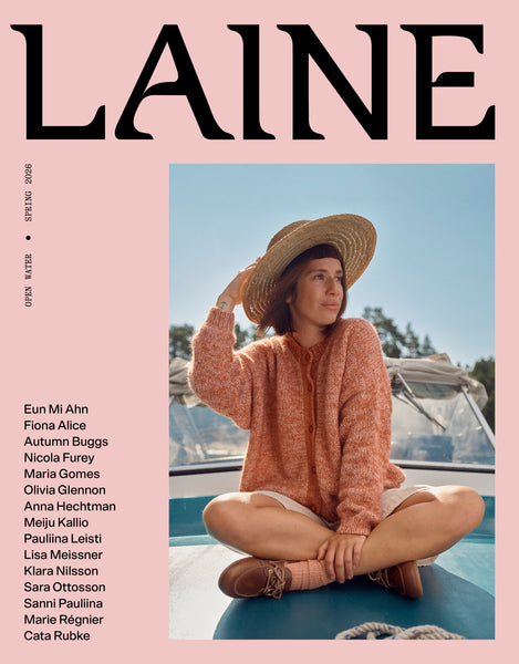 Magazine cover with a woman sitting on a car roof, wearing a pink sweater and straw hat, with 'Laine' branding.