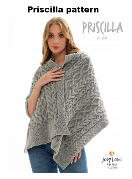 Woman wearing a grey, all over cabled knit wrap on a white background with Priscilla and brand logo