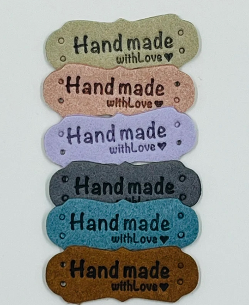 Six different color sew in labels with the words Handmade with Love and a small heart emoji. 