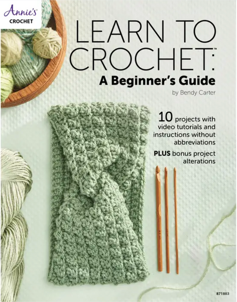 The cover says Learn to Crochet: a beginner's guide. it has a green crocheted headband and 3 different size crochet hooks
