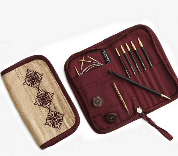 Set of tunisian croceht hooks in a red case with the hooks in their compartmens