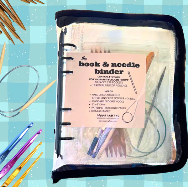 Hook and needle binder with storage compartments on a blue checkered background