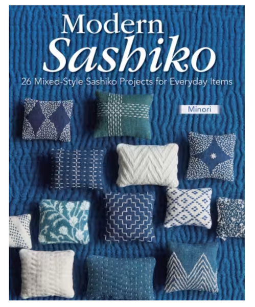 Book cover for 'Modern Sashiko' by Minori, featuring a blue textured background with multiple decorative throw pillows in navy, teal, and white sashiko patterns.
