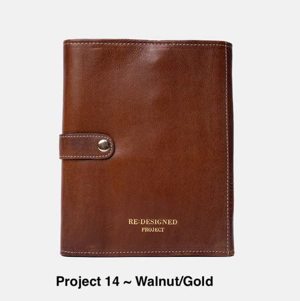 Project 14 in Walnut/Gold is a leather needle case holder for interchangeable needles with the log on the front that says Re:Designed Project