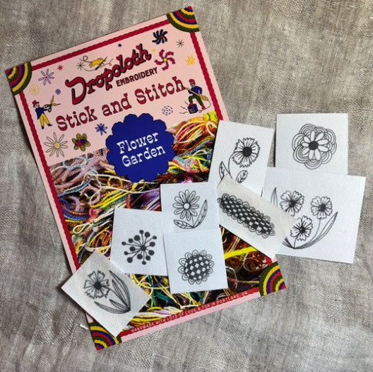 Embroidery book titled 'Stick and Stitch Flower Garden' with pattern sheets on a textured fabric background
