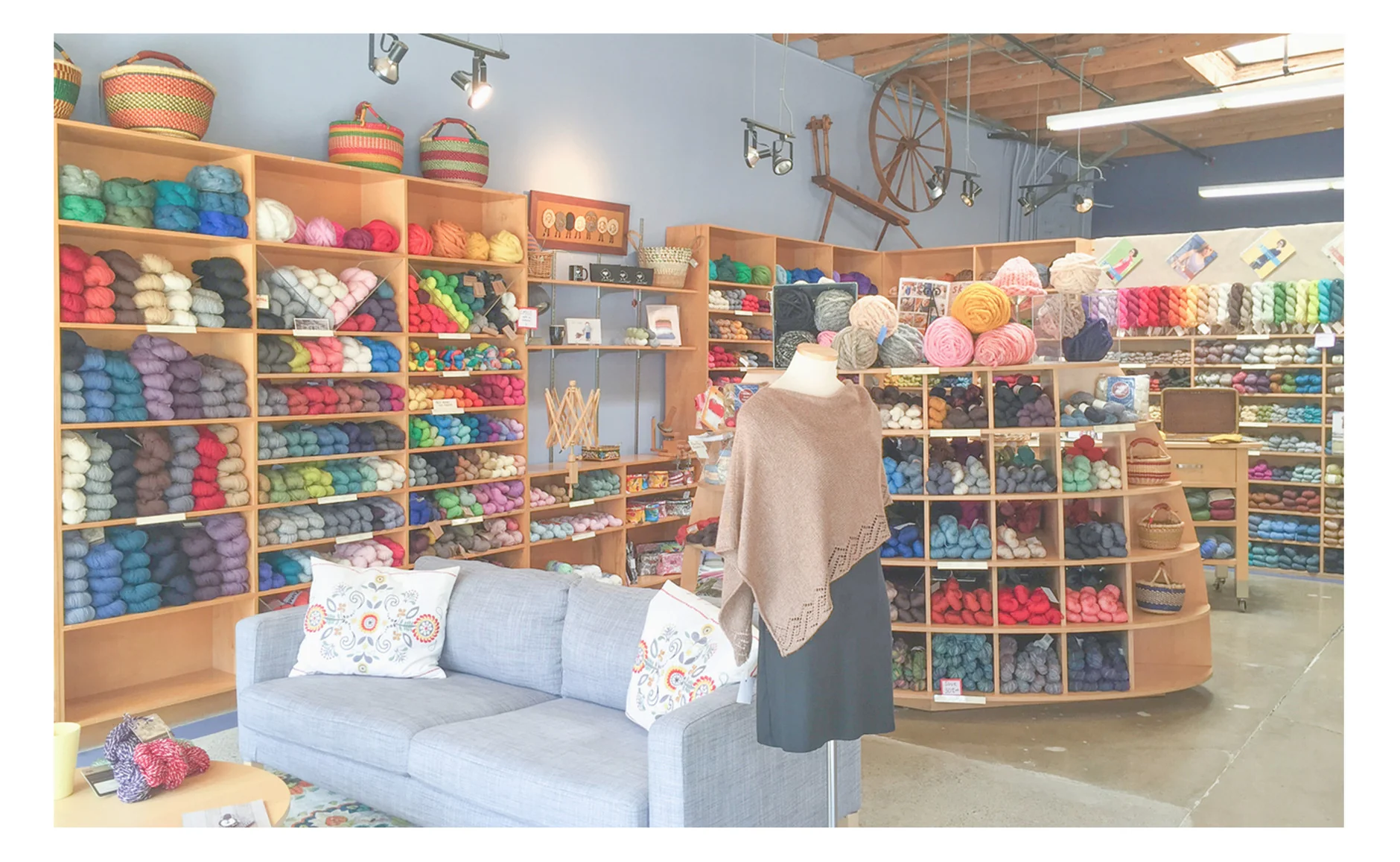 Interior image showing a seating area, yarn and sample knits.